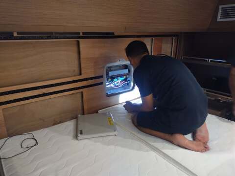 Technician working on a yacht electrical panel – SailorOne