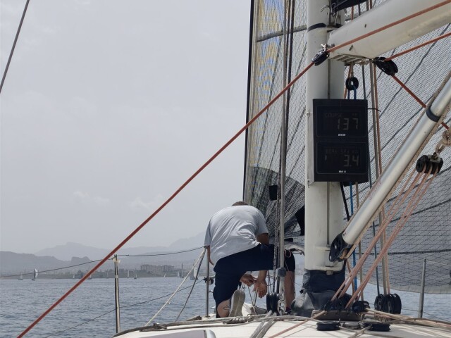 Transfer crew working on deck under sail – SailorOne