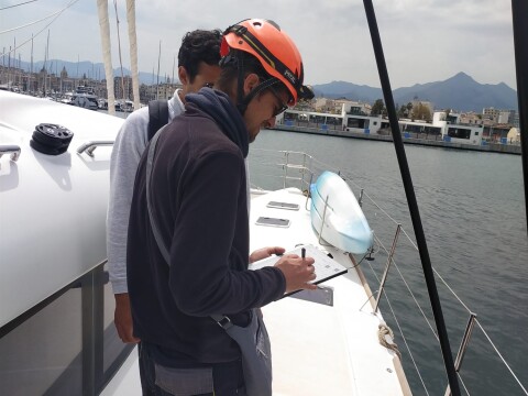 Surveyor taking notes during a technical inspection on deck – SailorOne